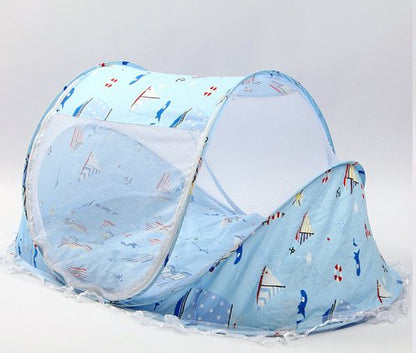 baby blue folding bed with sailboats on it